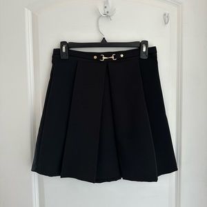 Black pleated mini skirt